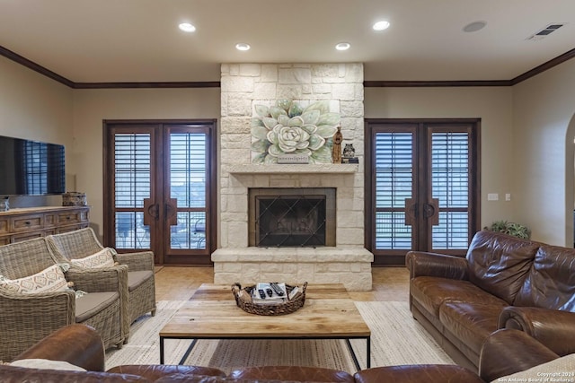 living room with a fireplace, french doors, and light hardwood / wood-style floors