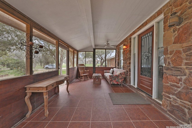 unfurnished sunroom with ceiling fan and a healthy amount of sunlight