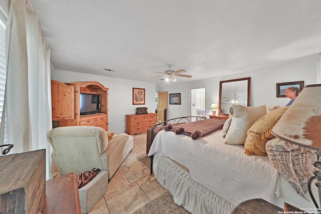 tiled bedroom featuring ceiling fan