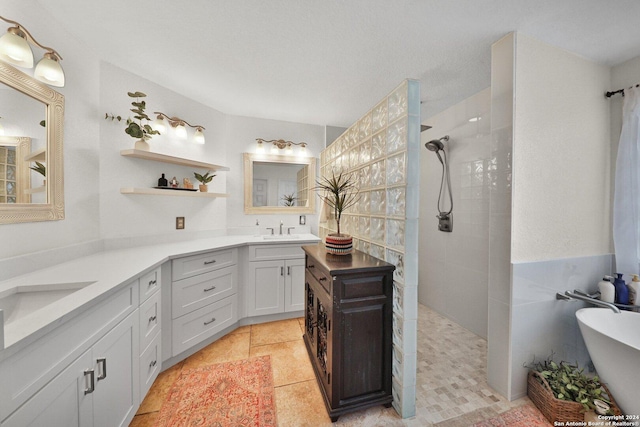 bathroom featuring tile patterned flooring, vanity, separate shower and tub, and tile walls