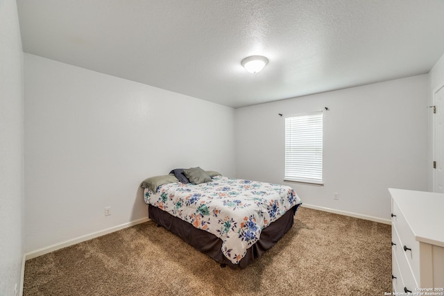 bedroom with a textured ceiling and carpet floors