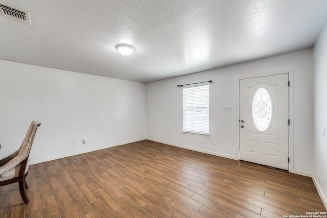 entryway with a textured ceiling