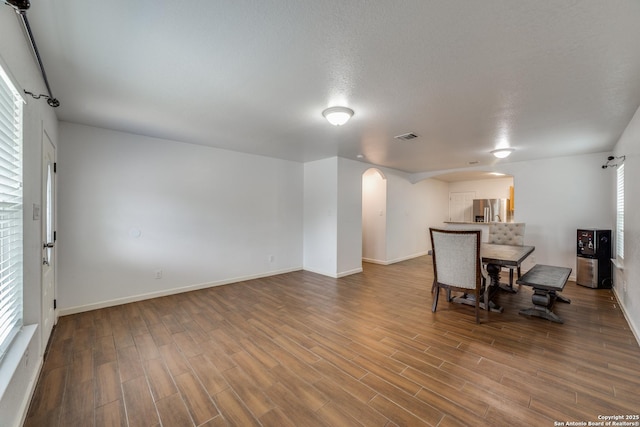 unfurnished dining area featuring a textured ceiling