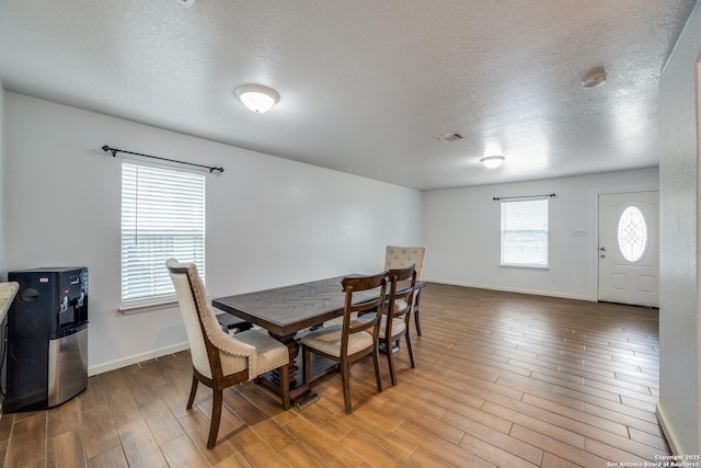 dining area with a textured ceiling