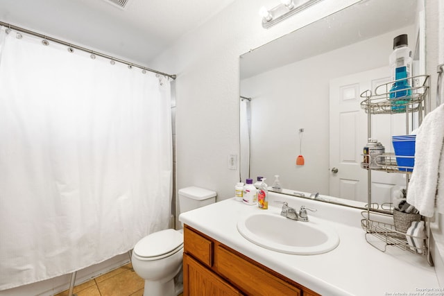 bathroom with tile patterned floors, vanity, and toilet