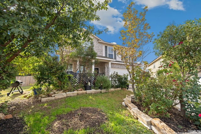 view of front of home featuring a front yard and a garage