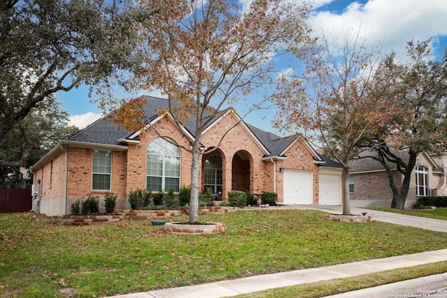 view of front of property with a garage and a front lawn