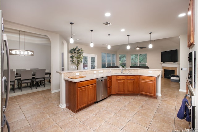 kitchen featuring pendant lighting, light tile patterned flooring, sink, and stainless steel appliances