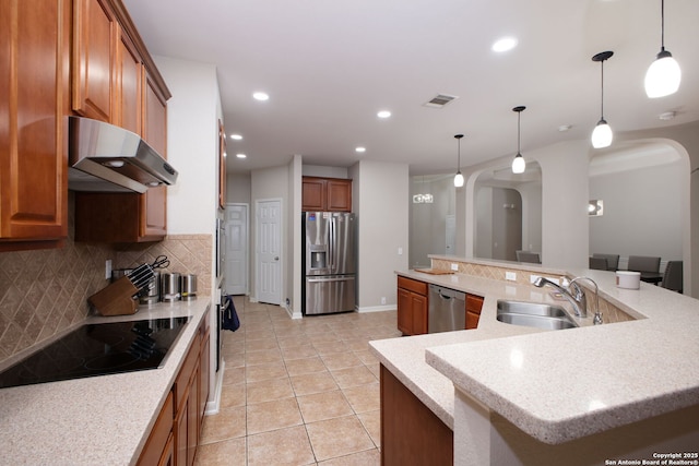 kitchen featuring sink, appliances with stainless steel finishes, pendant lighting, and ventilation hood