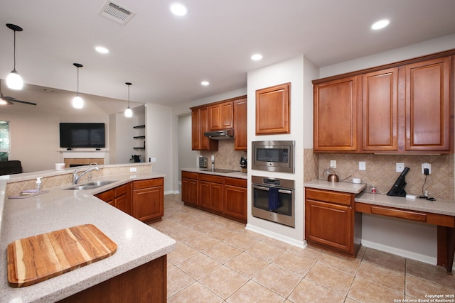 kitchen featuring backsplash, sink, light tile patterned floors, and stainless steel appliances