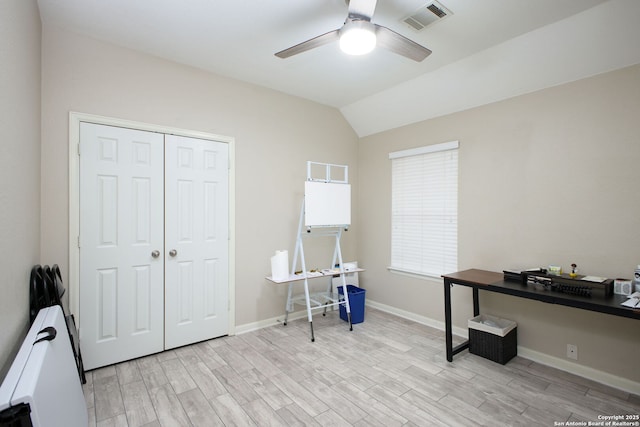 office featuring ceiling fan, light hardwood / wood-style floors, and vaulted ceiling