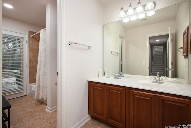 bathroom featuring tile patterned flooring, shower / bath combo, and vanity