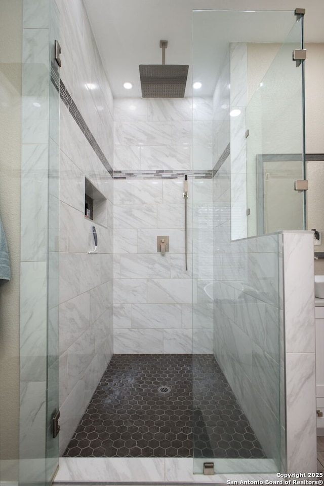 bathroom featuring a shower with door