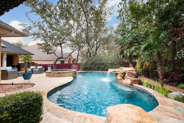 view of pool with pool water feature, outdoor lounge area, an in ground hot tub, and a patio