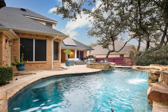 view of swimming pool with an in ground hot tub, pool water feature, and a patio area