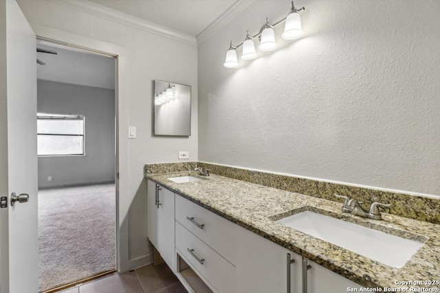 bathroom with tile patterned floors, vanity, and ornamental molding