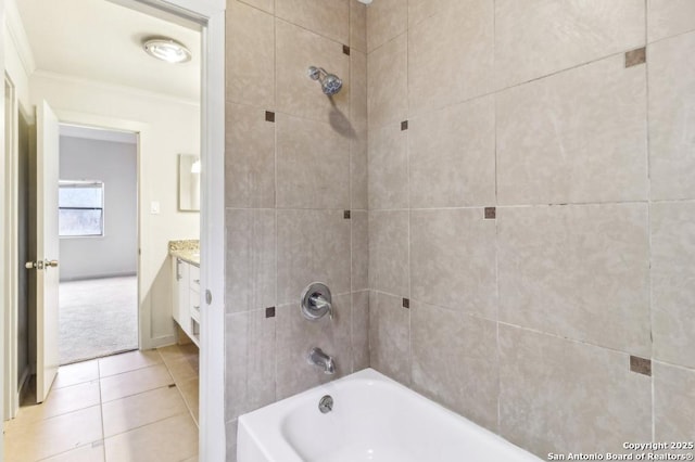 bathroom with tile patterned floors, vanity, tiled shower / bath combo, and ornamental molding