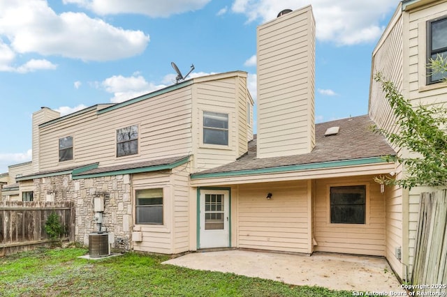 rear view of property with a patio and central AC