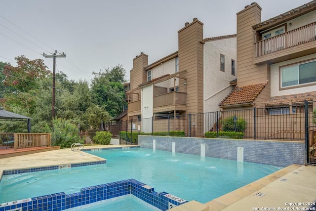 view of pool with pool water feature