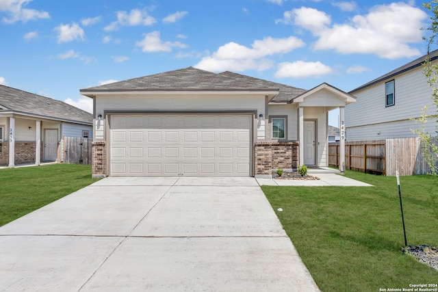 view of front of home with a garage and a front lawn