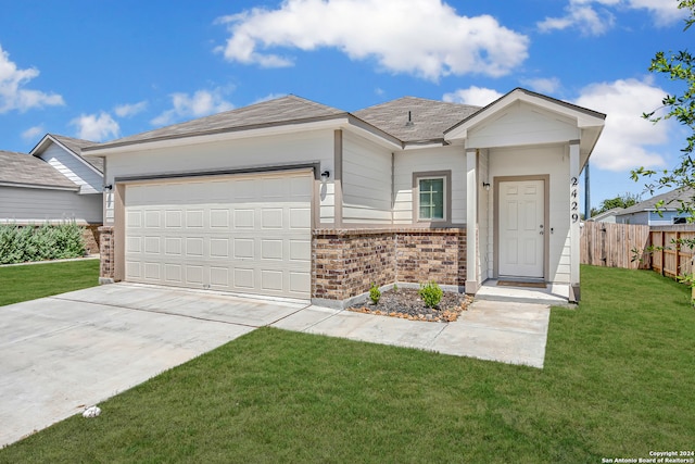 single story home with a garage and a front lawn