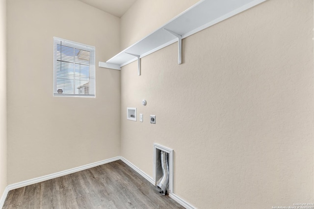 clothes washing area with gas dryer hookup, hookup for a washing machine, hardwood / wood-style floors, and hookup for an electric dryer