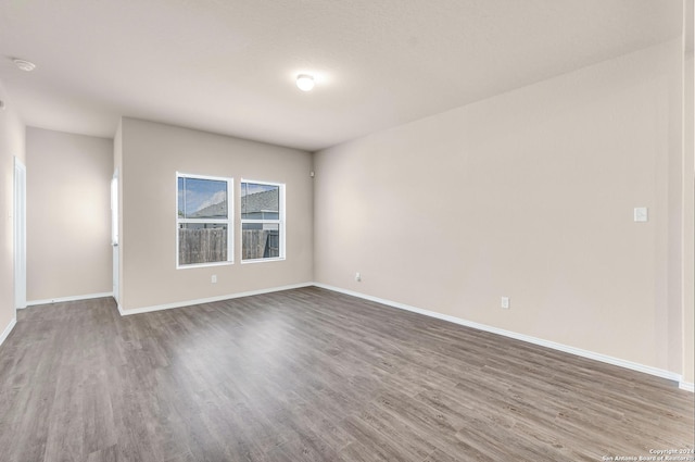 spare room with hardwood / wood-style flooring