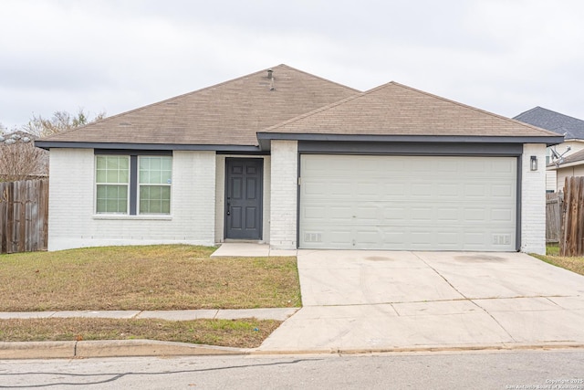 ranch-style house with a front yard and a garage