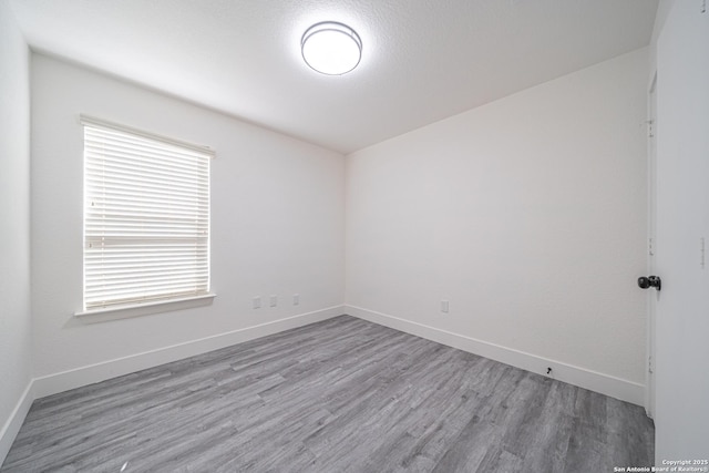 spare room with wood-type flooring