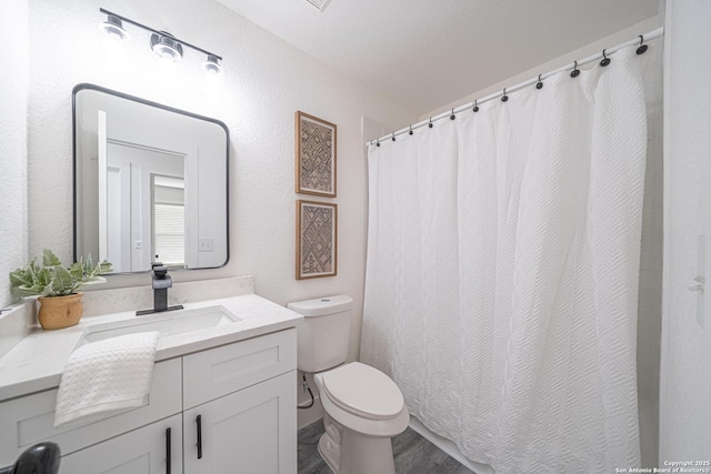 bathroom with hardwood / wood-style floors, vanity, and toilet