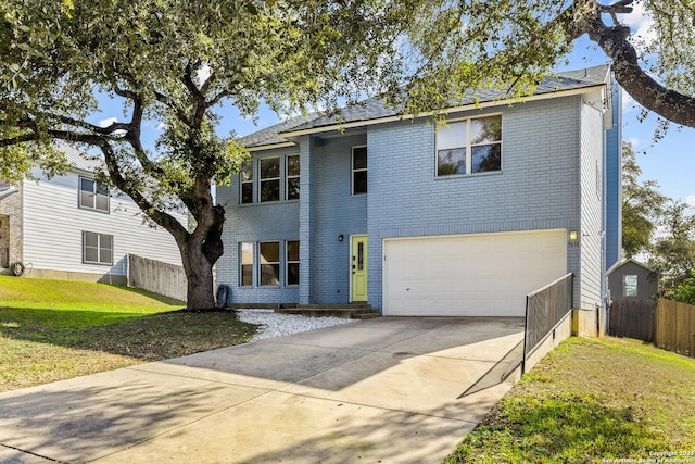 view of front of home with a front yard and a garage