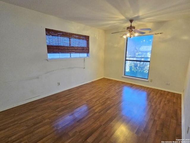 unfurnished room featuring ceiling fan and dark wood-type flooring