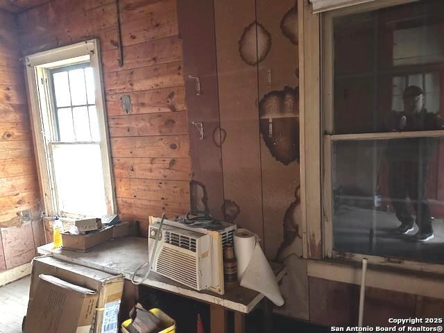 miscellaneous room featuring wooden walls