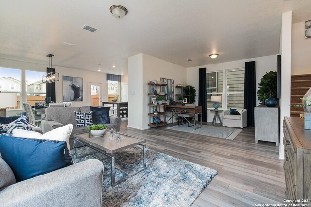 living room with hardwood / wood-style floors and a healthy amount of sunlight