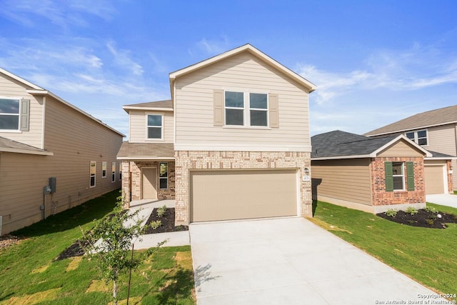 view of front of house featuring a front yard and a garage