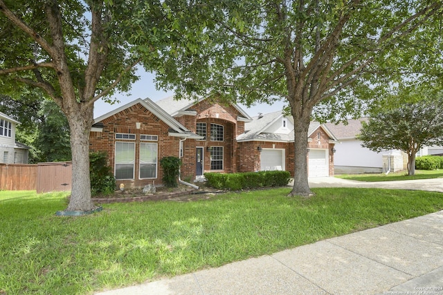 view of front of home featuring a garage and a front lawn