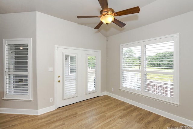 interior space featuring ceiling fan, light hardwood / wood-style floors, and lofted ceiling