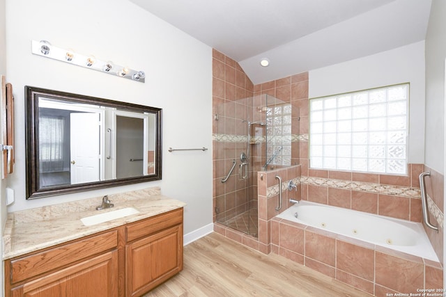 bathroom featuring vanity, separate shower and tub, wood-type flooring, and vaulted ceiling