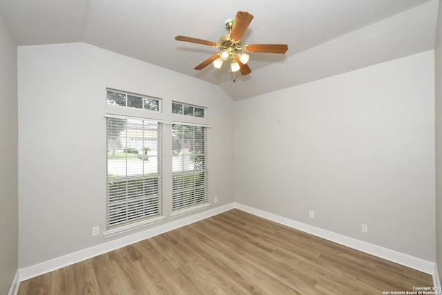 spare room featuring ceiling fan, light hardwood / wood-style floors, and lofted ceiling