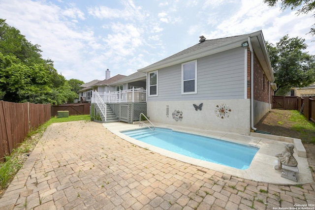 view of pool with a patio and a wooden deck