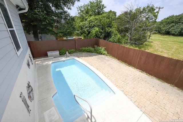 view of swimming pool with a patio area