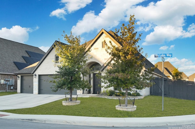 view of front of property featuring a garage and a front lawn