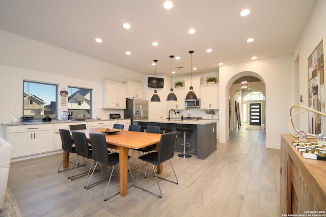 dining room featuring a healthy amount of sunlight and light wood-type flooring