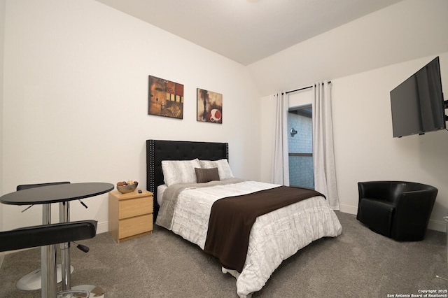 carpeted bedroom featuring lofted ceiling