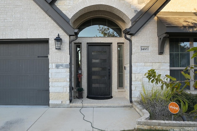 doorway to property with a garage