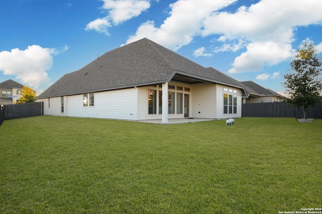 rear view of house with a patio area and a lawn