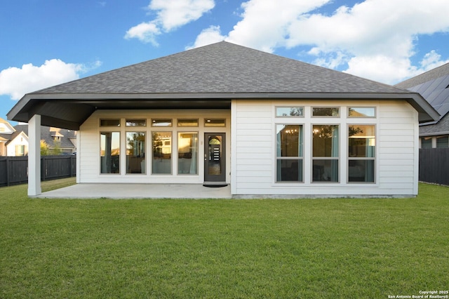 back of house with a lawn and a patio area