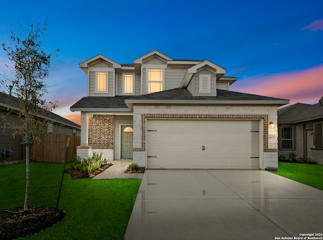 view of front of house with a yard and a garage