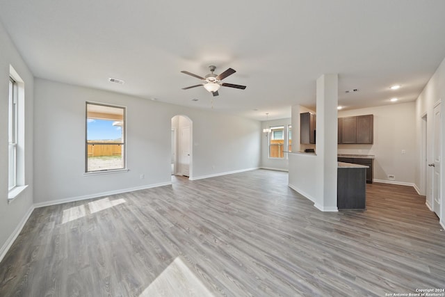 unfurnished living room with ceiling fan and light hardwood / wood-style floors