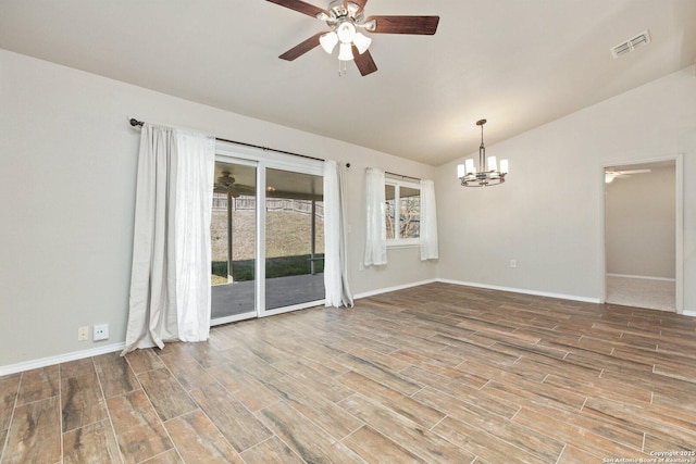 spare room with lofted ceiling and ceiling fan with notable chandelier